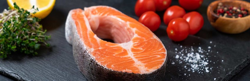 Piece of salmon on chopping board